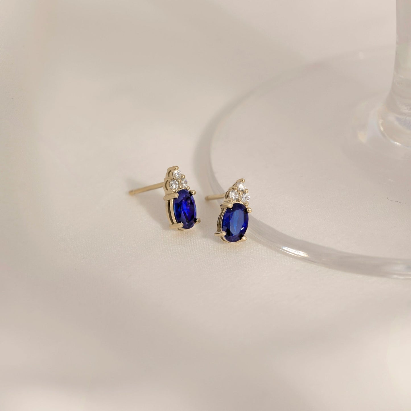 Oval Cut Created Sapphire With Trio Lab Grown Diamond Accent Stud Earrings