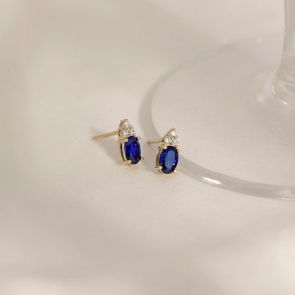 Oval Cut Created Sapphire With Trio Lab Grown Diamond Accent Stud Earrings