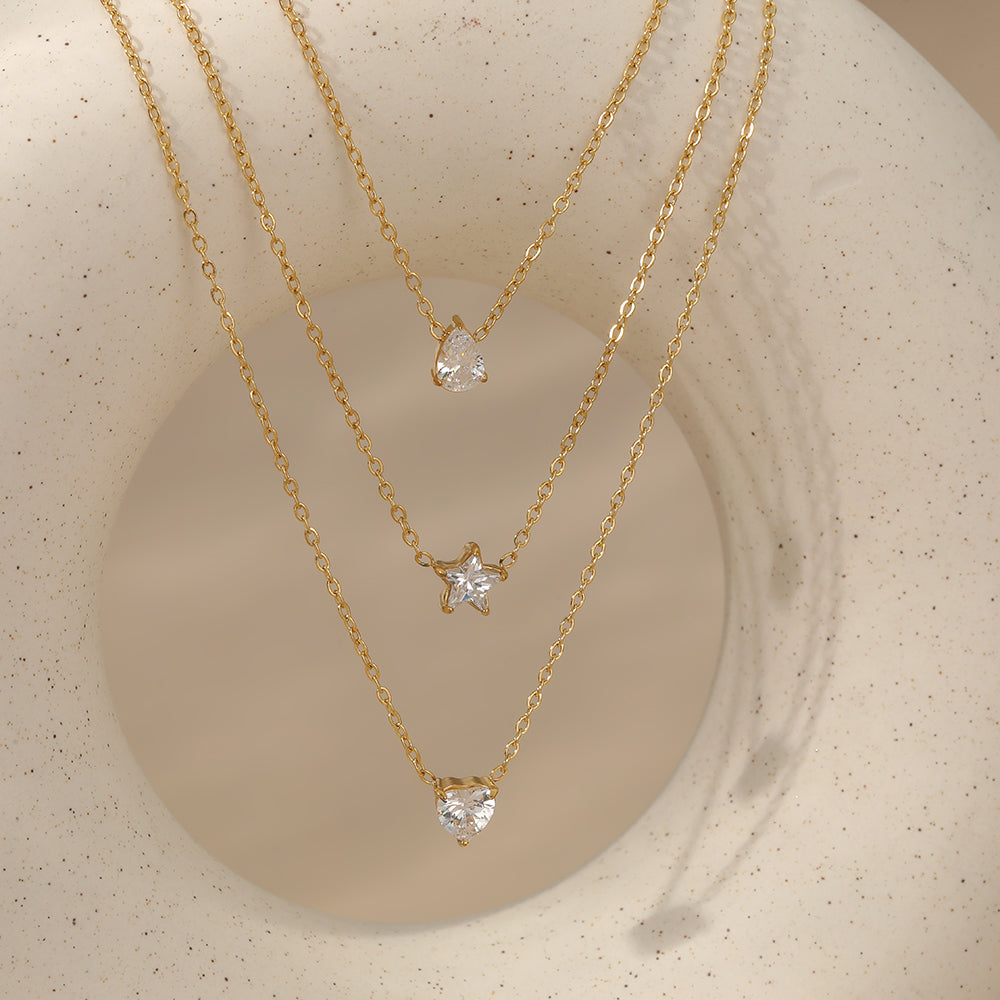 Aquabliss Triple Layer Gold-Tone Stainless Steel Necklace with Teardrop, Star, and Heart Pendants