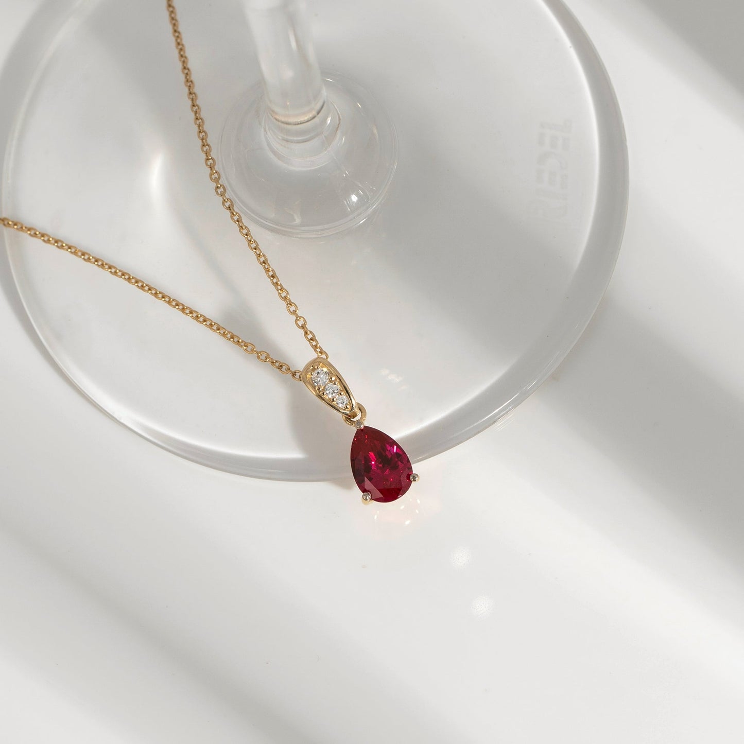 Pear Cut Created Ruby With Lab Grown Diamond Accent Pendant Necklace