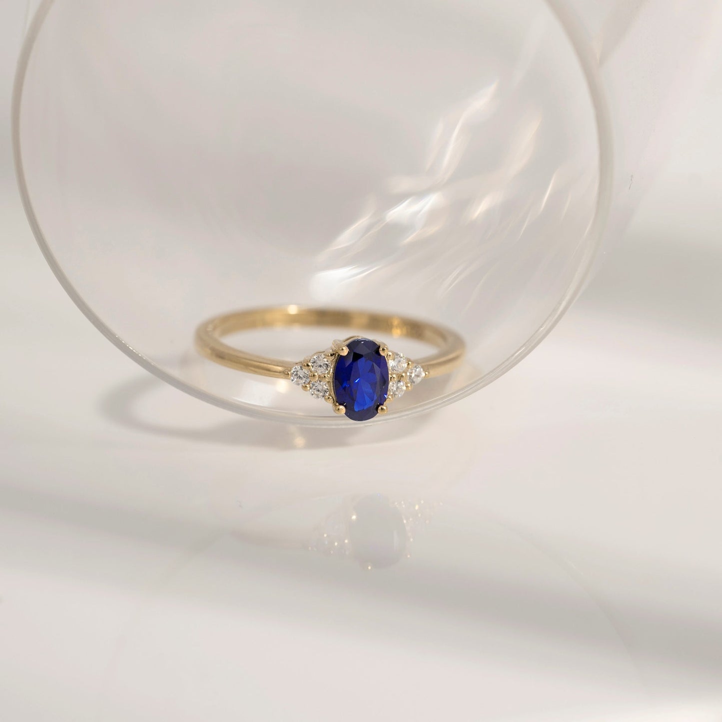 Oval Cut Created Sapphire With Trio Lab Grown Diamond On Shank Engagement Ring