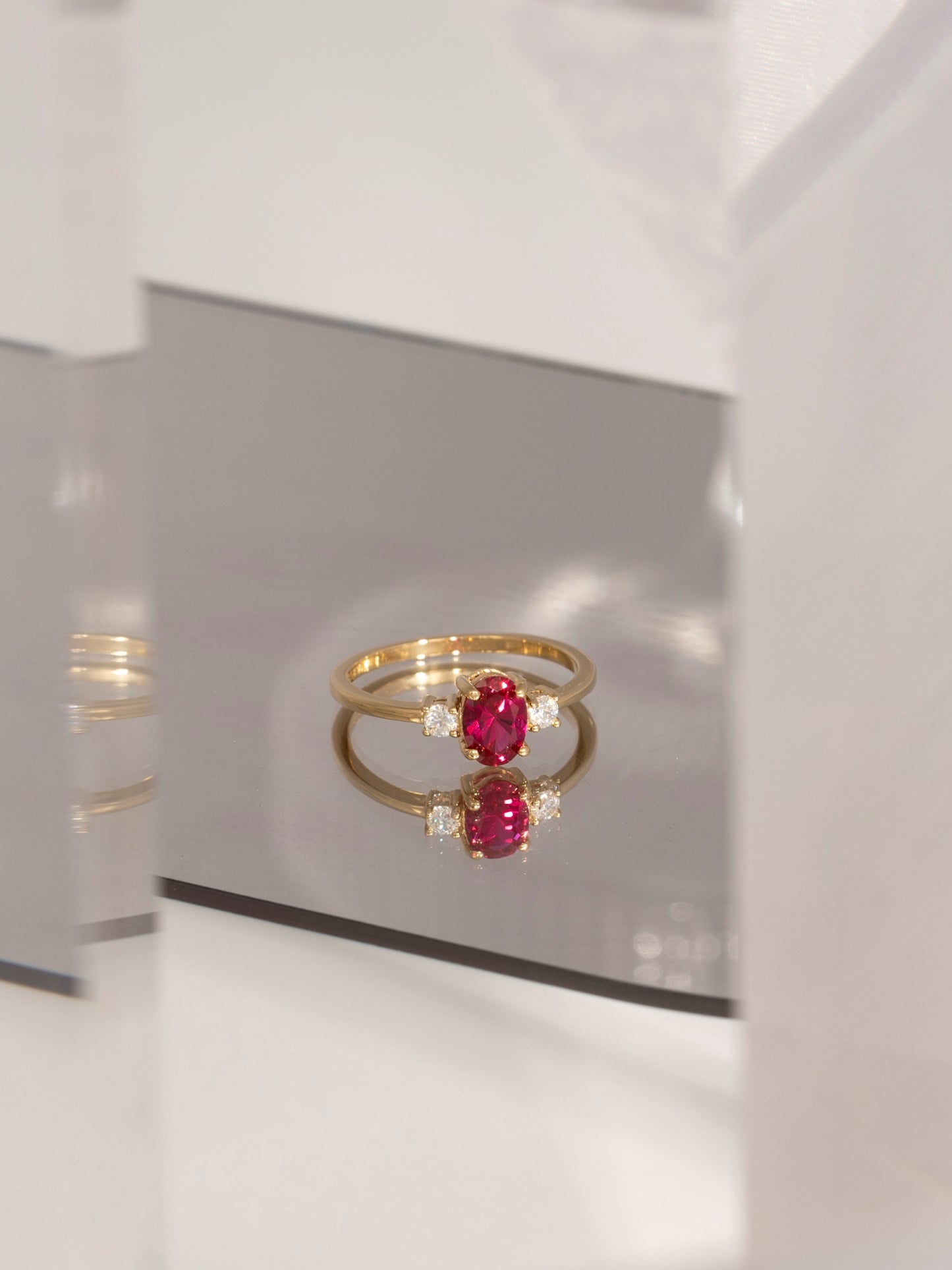 Oval Cut Created Ruby And Lab Grown Diamond Three Stones Ring